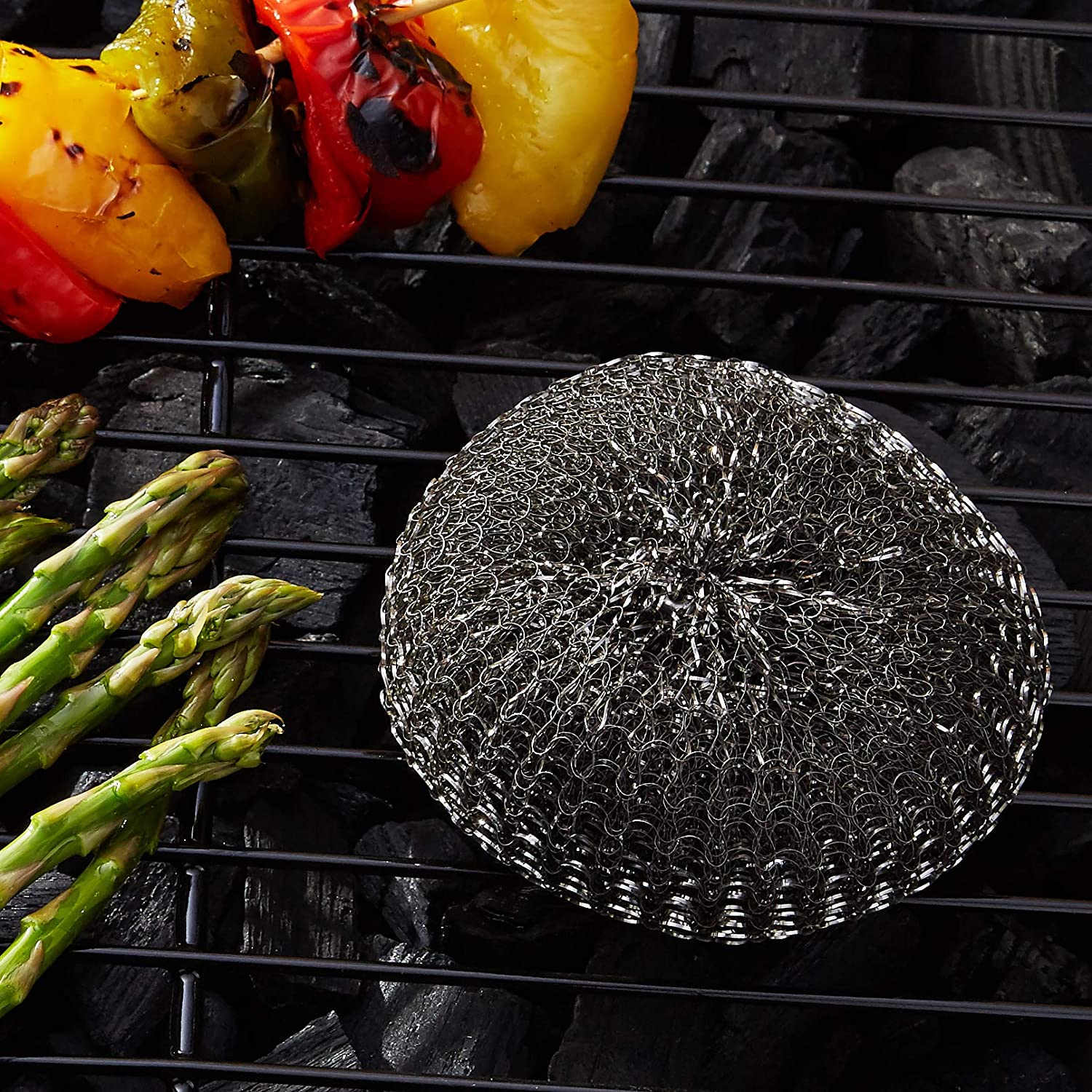 Outset Replacement Mesh Scrubbers Placed on the Grill with Asparagus and Veggies