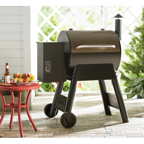 Traeger Pro Series 22 Bronze  Pellet Grill Lifestyle with Sunlight and Small Table Beside it