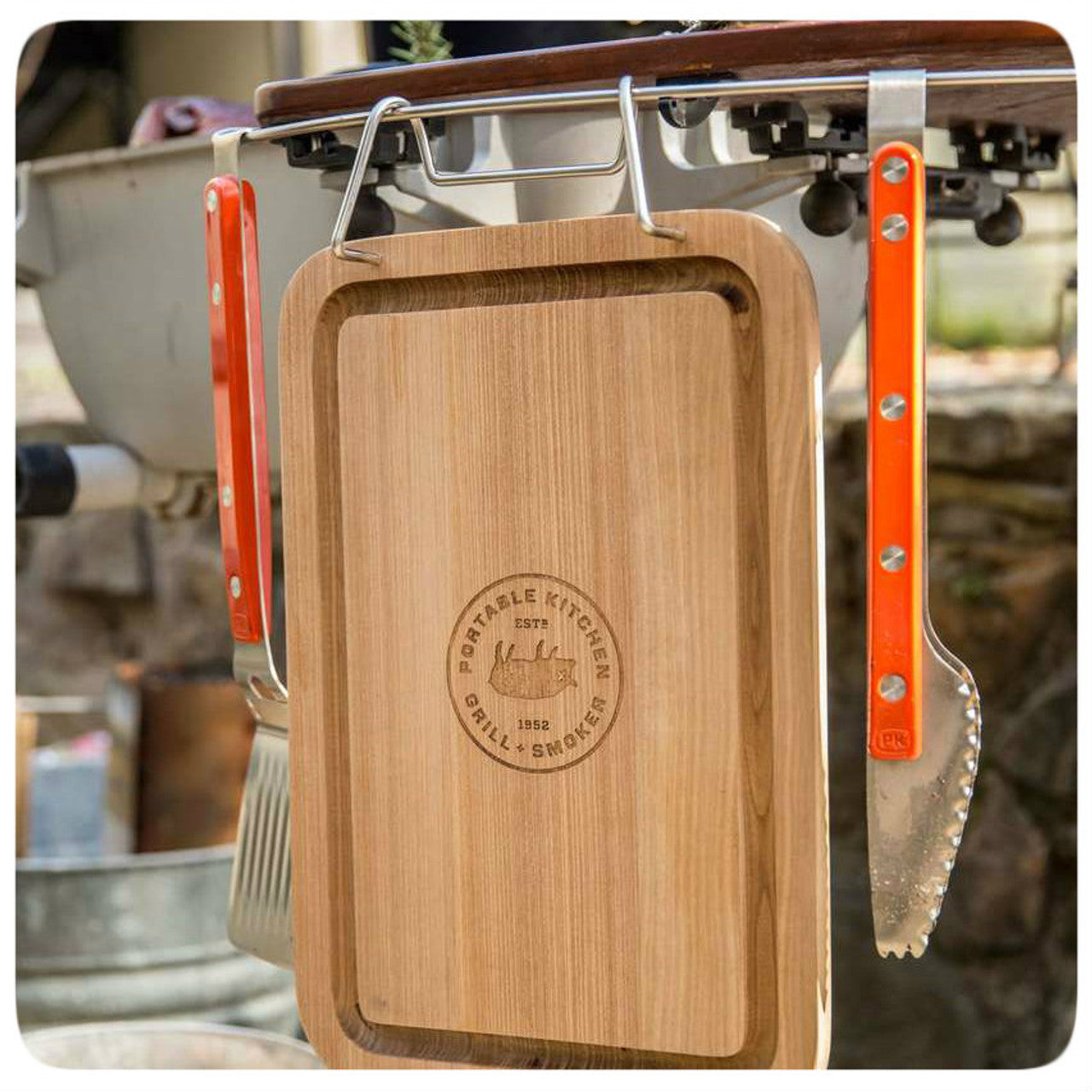Pk Grills Durable Teak Cutting Board Lifestyle Hooked with Spatula and Tong