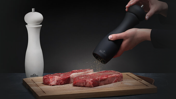 Napoleon Salt and Pepper Grinder Set Lifestyle Seasoning the Steak
