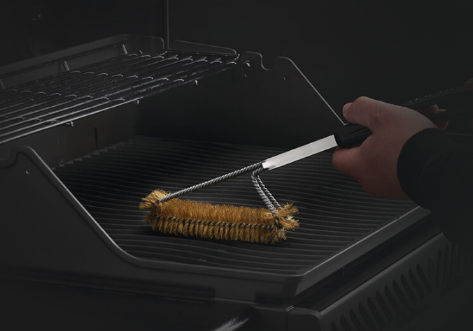 Napoleon Triple-Row Grill Brush with Brass Bristles Used in a Grill