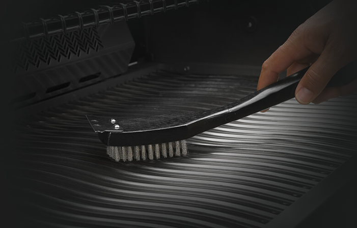 Napoleon Grill Brush with Stainless Steel Bristles Used in a Grill