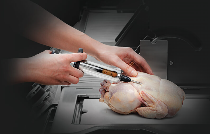 Napoleon Stainless Steel Marinade Injector Injecting the Chicken