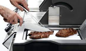 Napoleon Pro Executive Chef Knife on the Grill Cuts Steaks