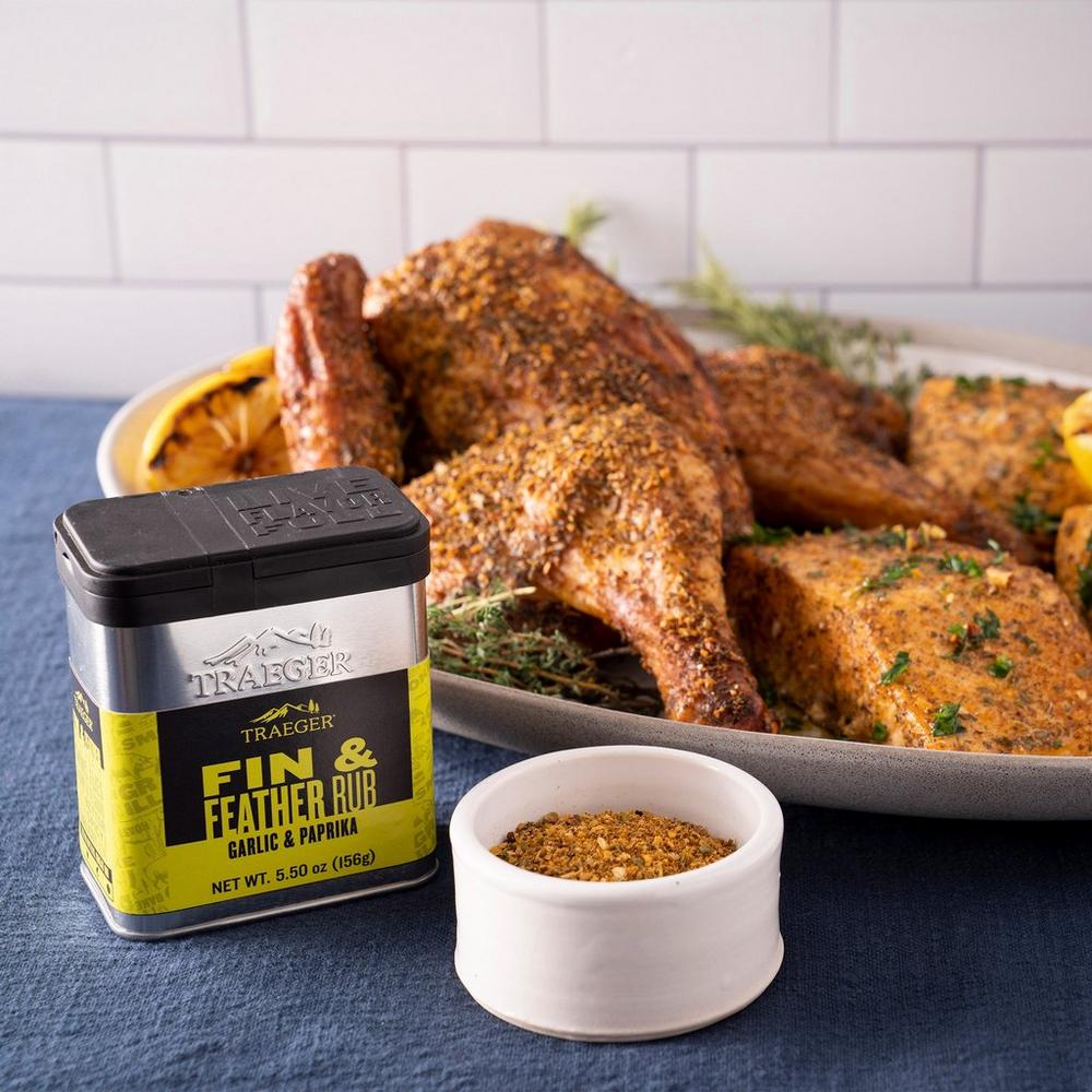 Traeger Fin and Feather Rub Lifestyle on the Table with Chicken and Salmon