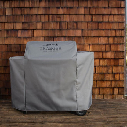 Traeger Ironwood 885 Grill Cover Full Length Lifestyle Covering the Grill on the Wood Wall