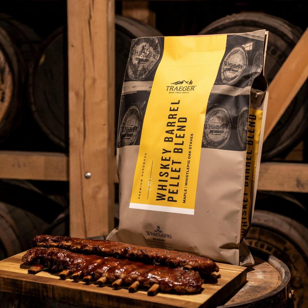 Traeger WhistlePig Whiskey Barrel Pellets Lifestyle on the Barrel with Steak Ribs
